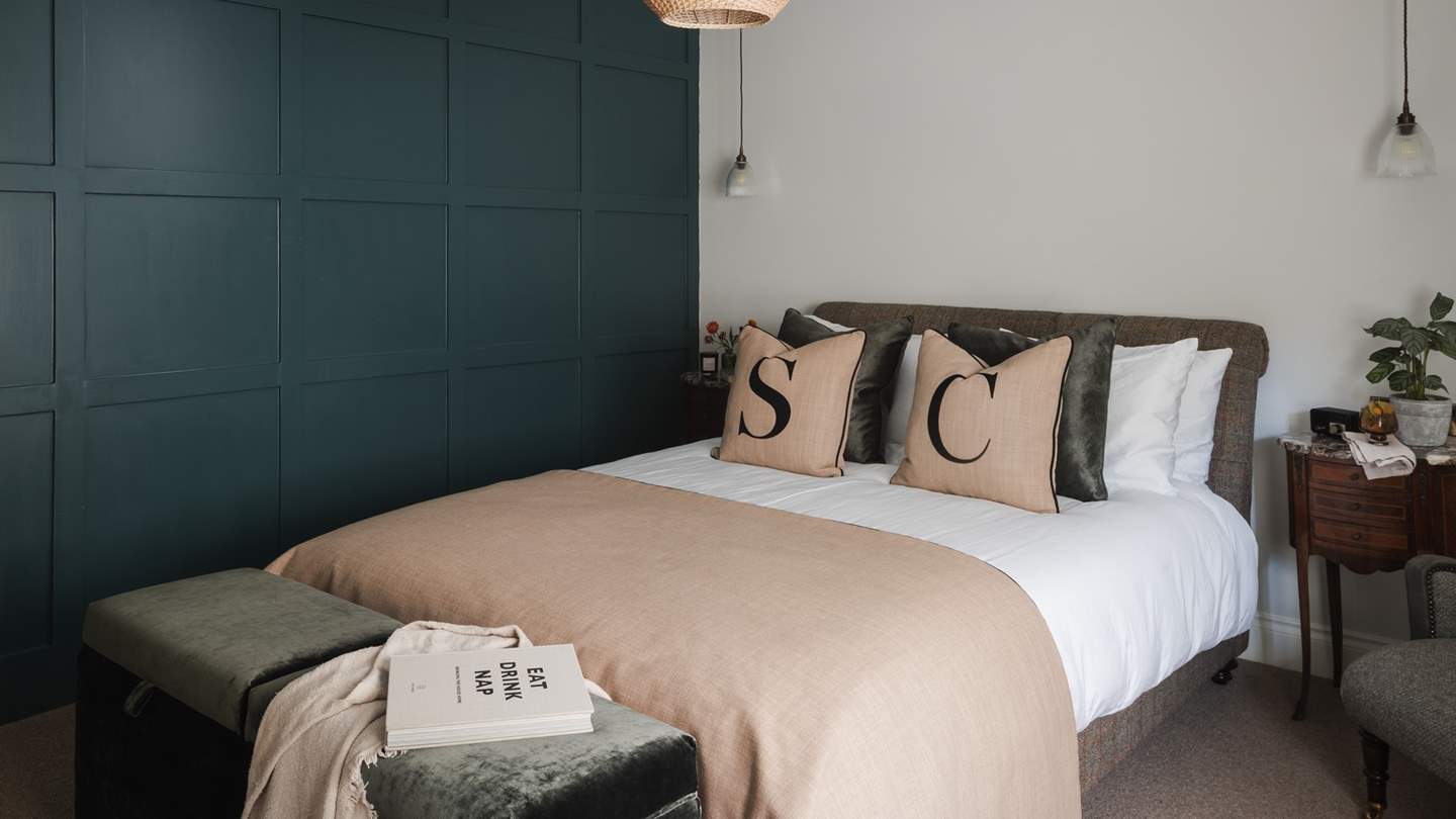 A forest green, built-in triple wardrobe provides plenty of storage