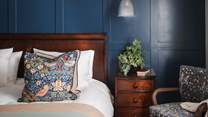 With a feature wall adorned in Farrow & Ball’s Hague Blue, this room is bathed in dreamy tones