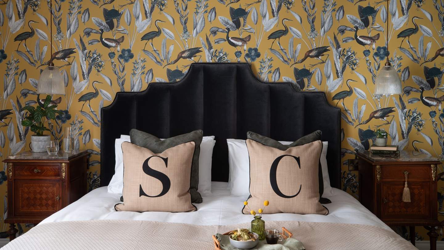 Light, restful hues dress the room, while exposed beams add eye-catching detaill