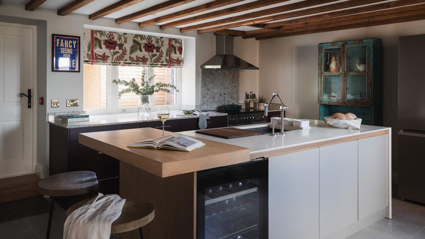 Situated beside the entertainment room, you’ll find a beautifully bespoke third kitchen, with sleek granite worktops