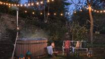 Step outside to uncover a dreamy wood-fired hot tub, nestled beneath twinkling festoon lighting 