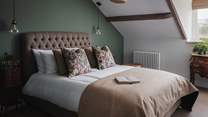 The sixth bedroom comes in the form of a pretty-as-a-picture sanctuary complete with a king size bed with Harris Tweed headboard