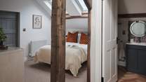 At the centre, a double bed resides with Rise and Fall cotton bed linen