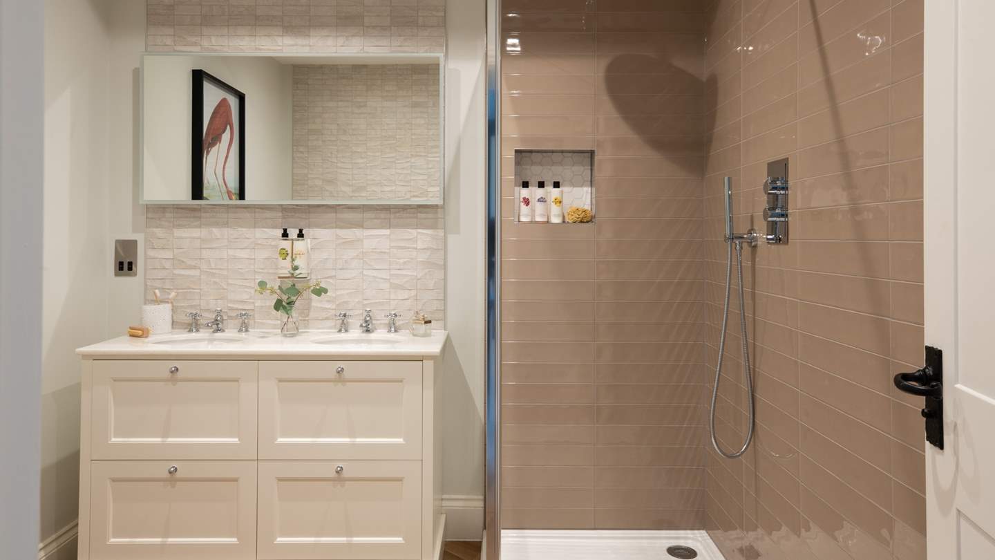 Coupled with this room is an ensuite bathroom with a walk-in waterfall shower for luxurious self-care rituals