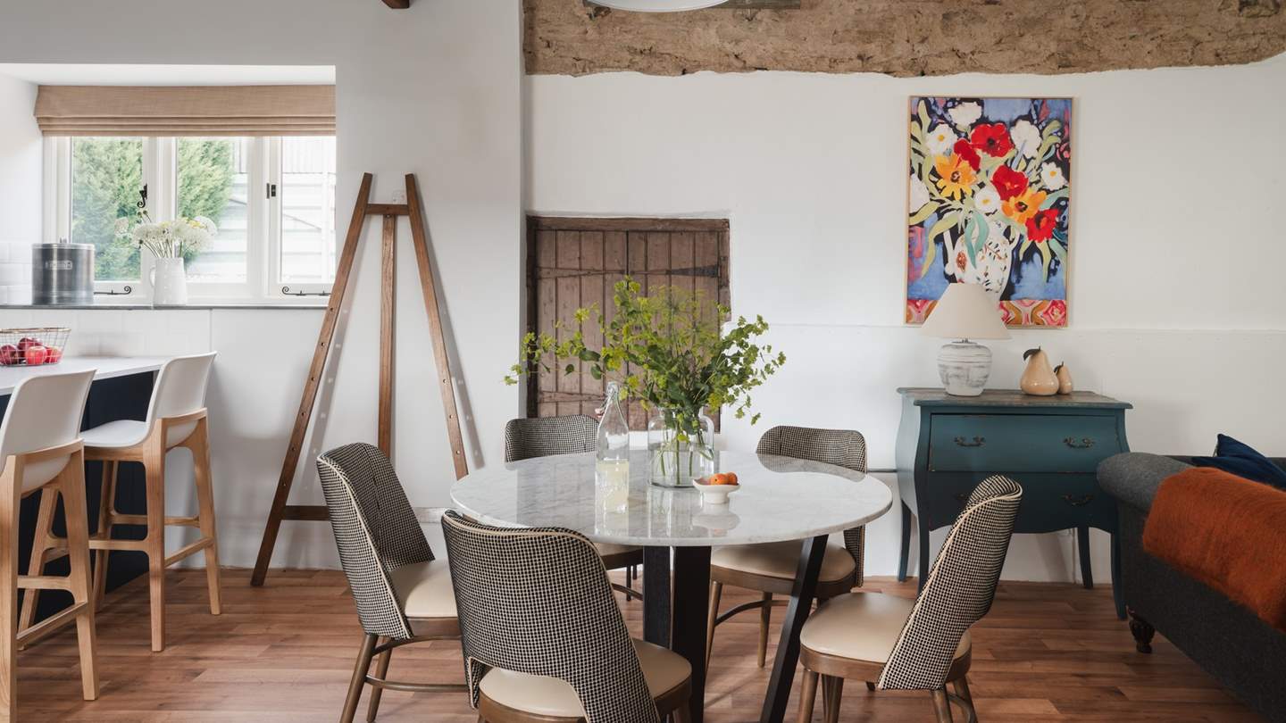 This exquisite space is framed by high, vaulted ceilings with exposed beams