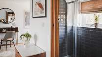 A stylish bathroom is home to a walk-in shower...