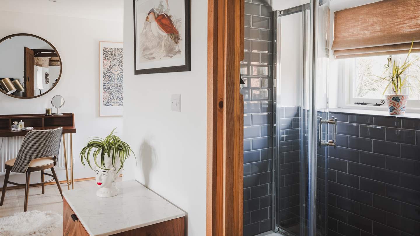 A stylish bathroom is home to a walk-in shower...