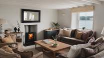 Dreamy fireside moments await in the heavenly living area, adorned with interiors by Neptune 