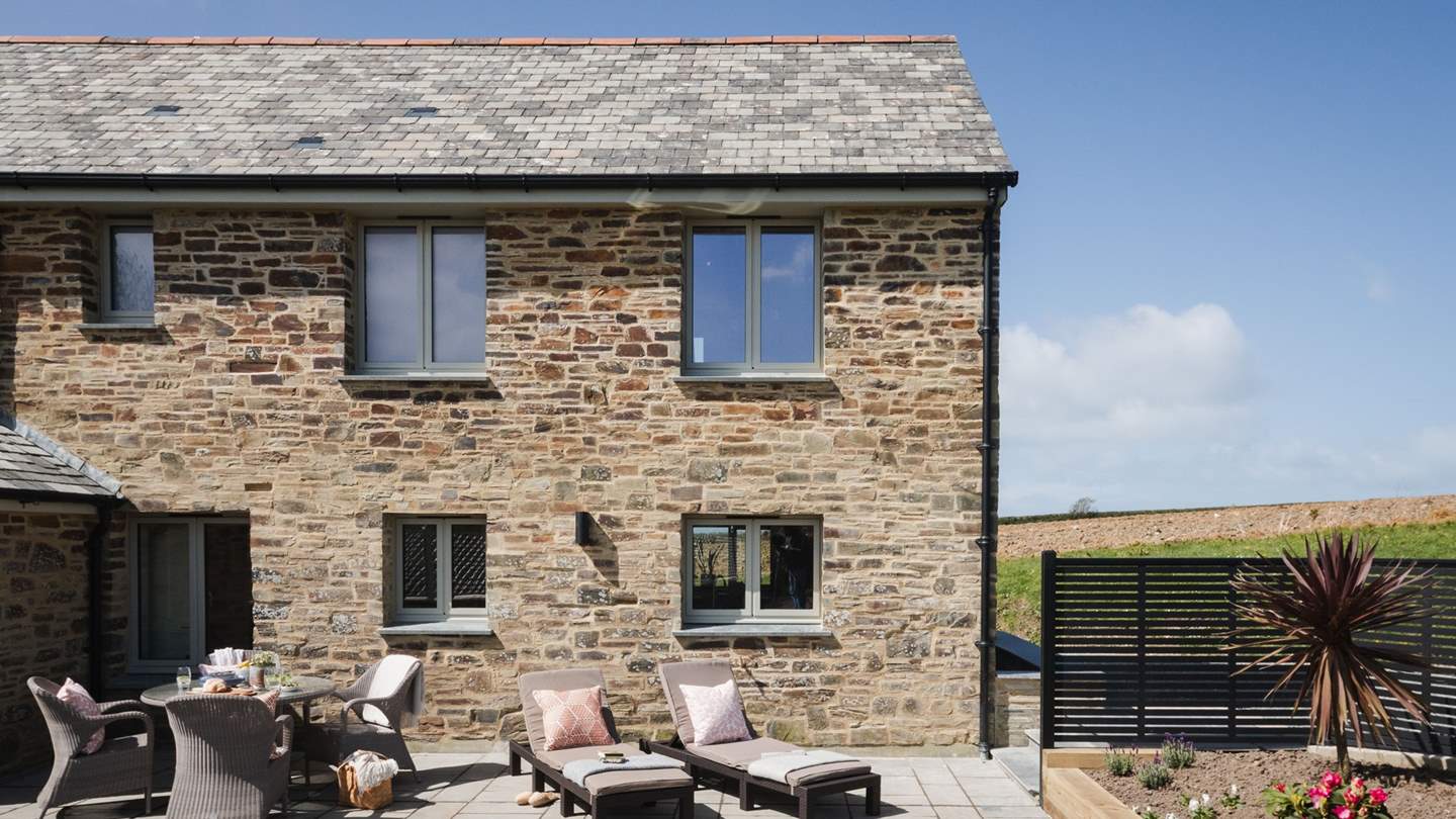 Step outside to uncover the pretty garden, a verdant space embraced by fencing and budding hedgerows