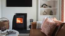 In the cooler months, luxuriate in the warmth of the wood burning stove for wintertime bliss