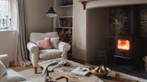Set in the spacious inglenook fireplace resides the handsome wood burning stove