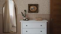 For storing your belongings, there is a chest of drawers and a built-in wardrobe