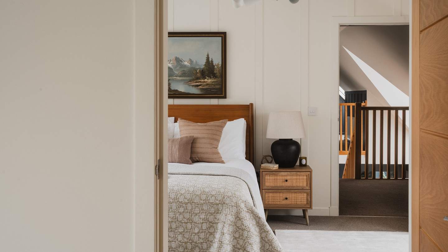 The third bedroom is a dream, adorned in a symphony of neutral tones 
