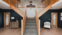 Take the breath-taking, double wooden staircase to find three further bedrooms...