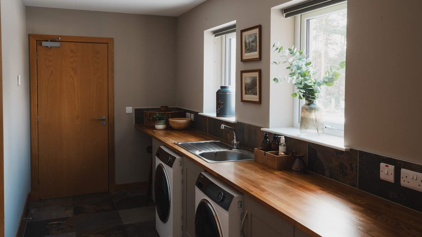 A washing machine and tumble dryer reside in the utility 