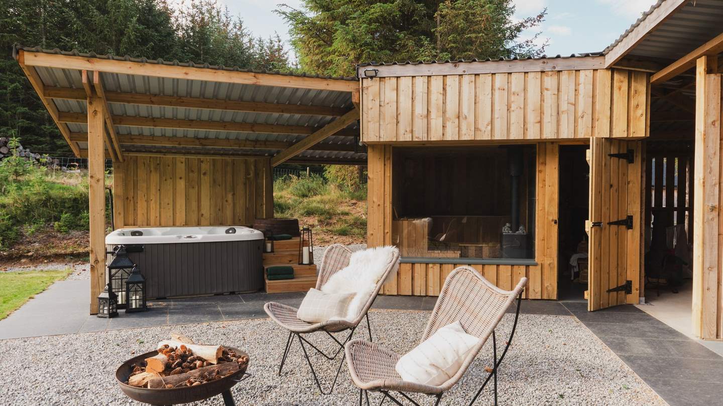 Unwind in the balmy waters of the electric hot tub with a glass in hand