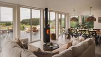 A charming wood burning stove draws your eye to the views beyond Birkenbaud in the main open-plan living space 