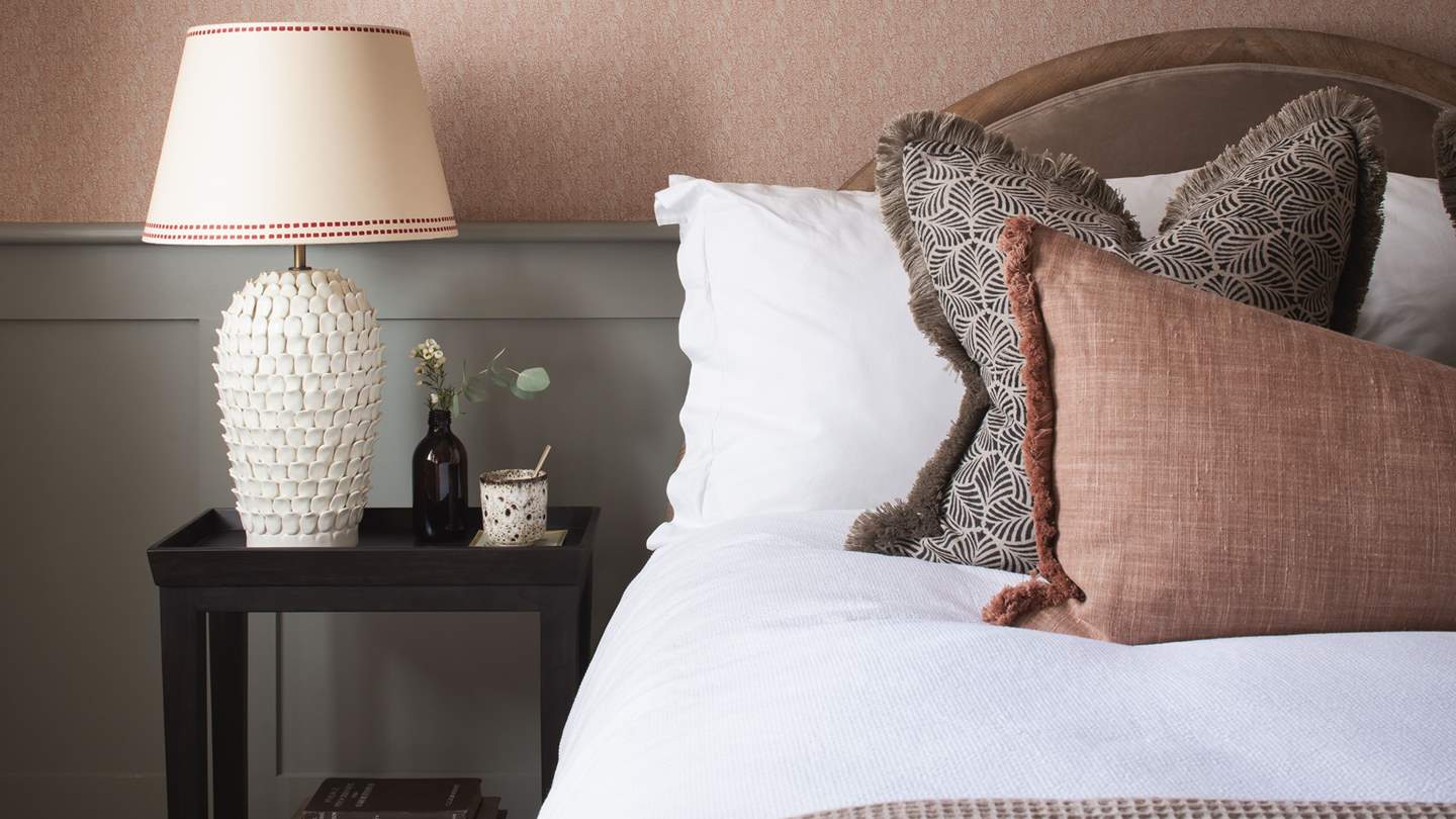 This swoon-worthy sanctuary holds a cushion-clad super king bed, adorned in Egyptian cotton bedding, a lavish throw and an array of beautiful finishing touches