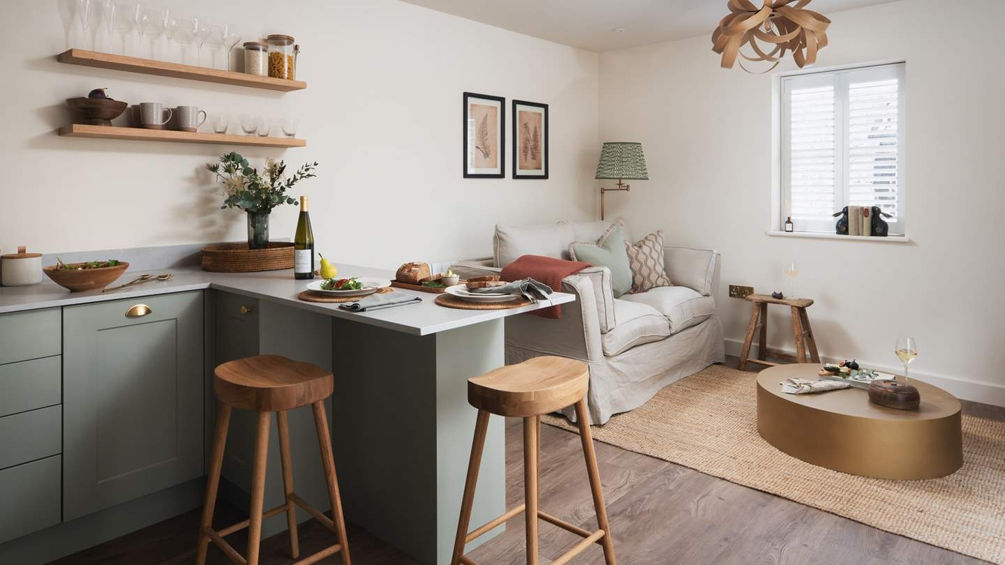 Settle down for cosy living moments in Ettie's snug lounge space, featuring a Tom Raffield pendant light