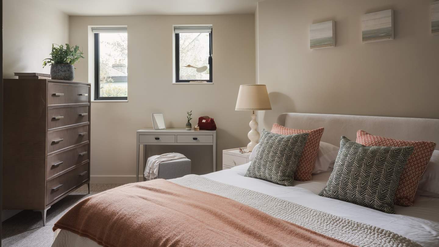 Adorned in neutrals and soft blush tones, the second air-conditioned bedroom with a super-king is equally cosy