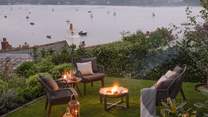 Luxe outdoor furnishings for twilight soirées gathered around the firepit 