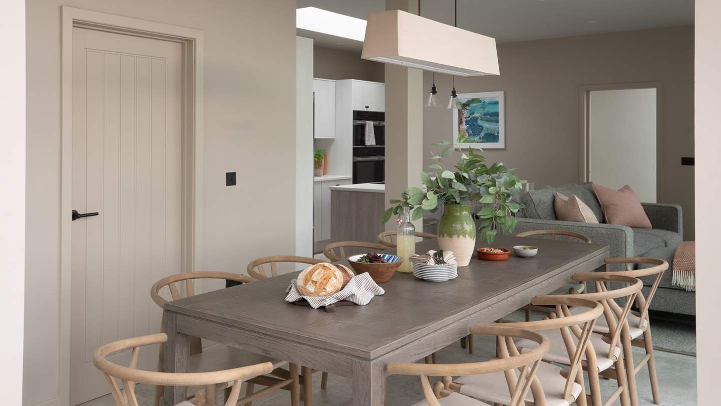 An additional, small seating area with a Smart TV and Sky Sports can be found next to the dining table, complete with a comfy grey corner sofa and chaise