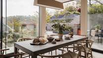Adorned in soft, grey hues and framing the stunning tiered garden and River Dart, you’ll find a dreaming dining space