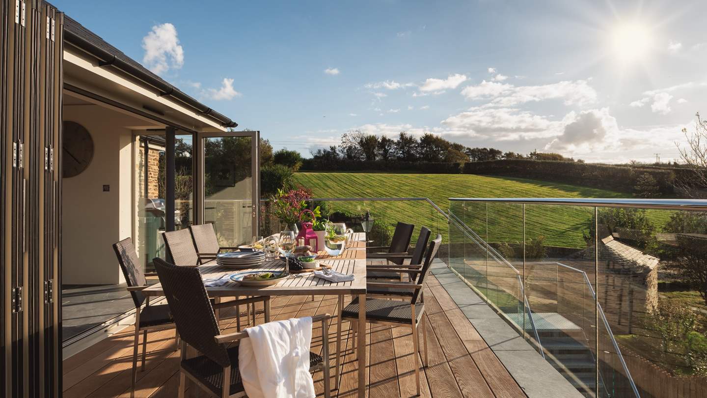 Bi-fold doors open onto a delightful decked terrace