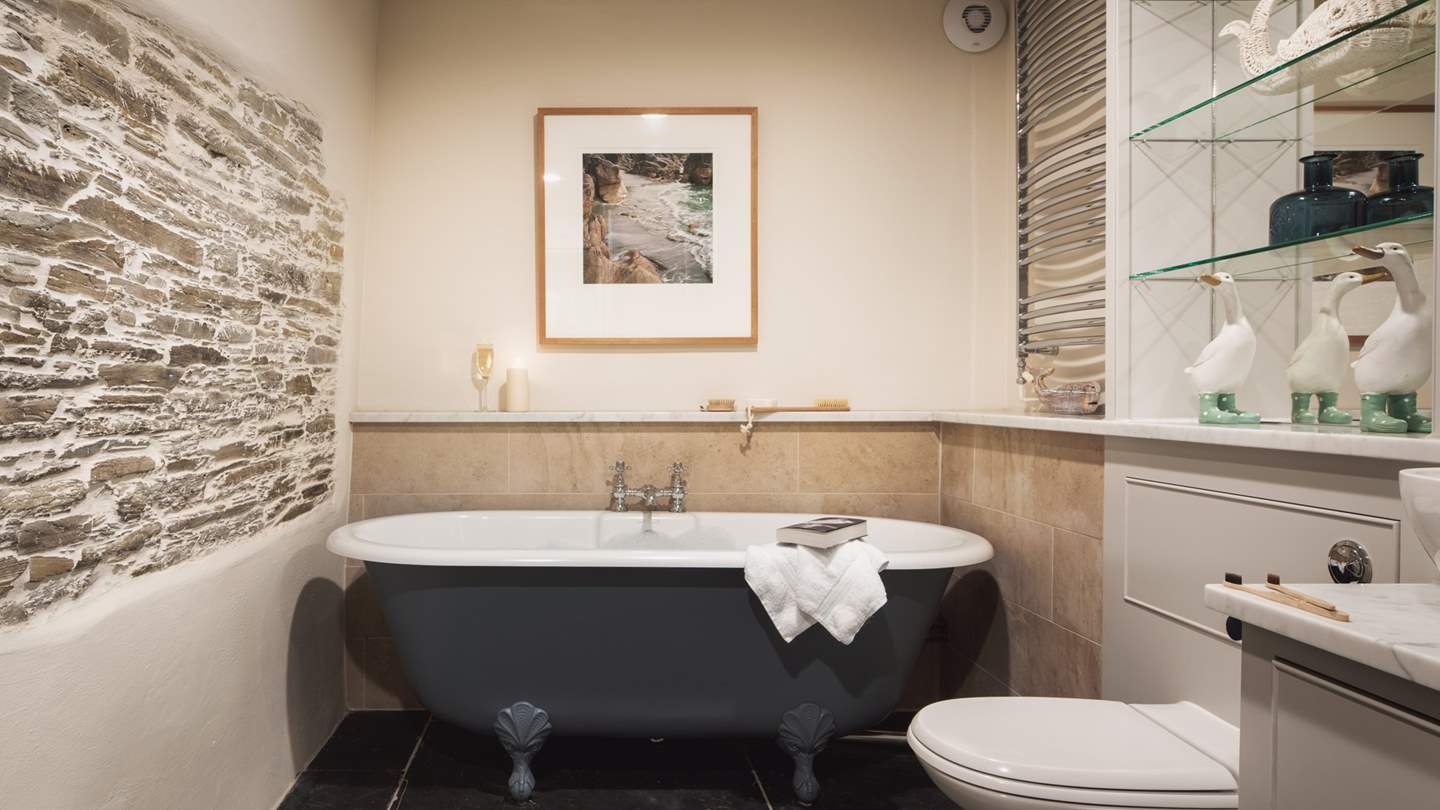 The family bathroom boasts a stunning roll top bath and a walk in shower 