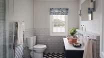 Uncover the ensuite bathroom with white and blue tiles and a walk-in shower