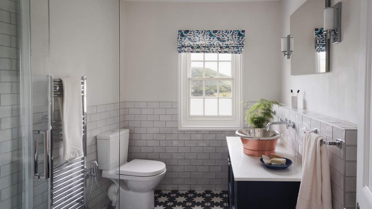 Uncover the ensuite bathroom with white and blue tiles and a walk-in shower