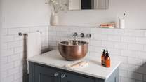 Featuring a beautiful copper basin and a walk-in shower for self-care rituals