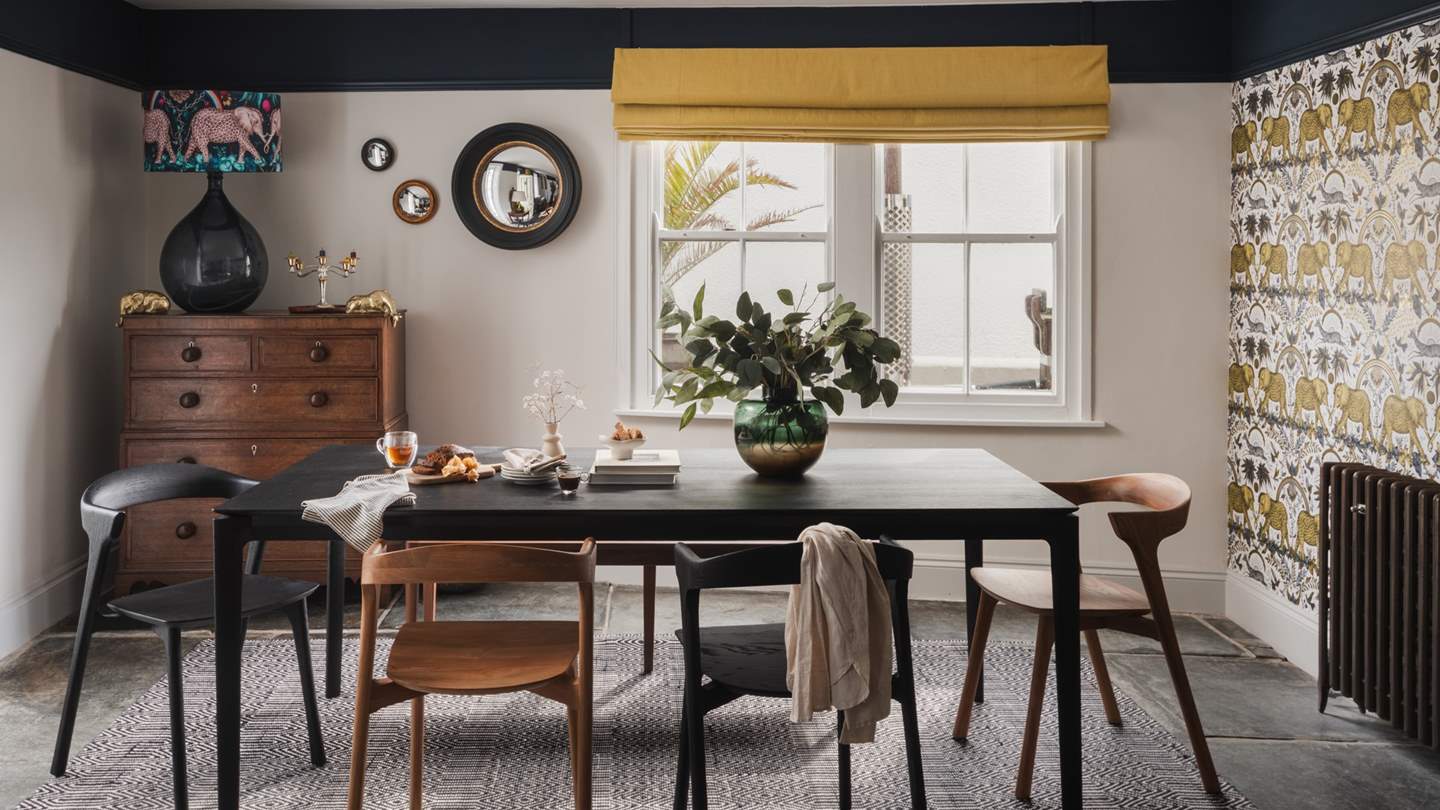 Adjoining the lounge in an open-plan design, the dining room features an Ethnicraft Table with four oak chairs and a walnut bench