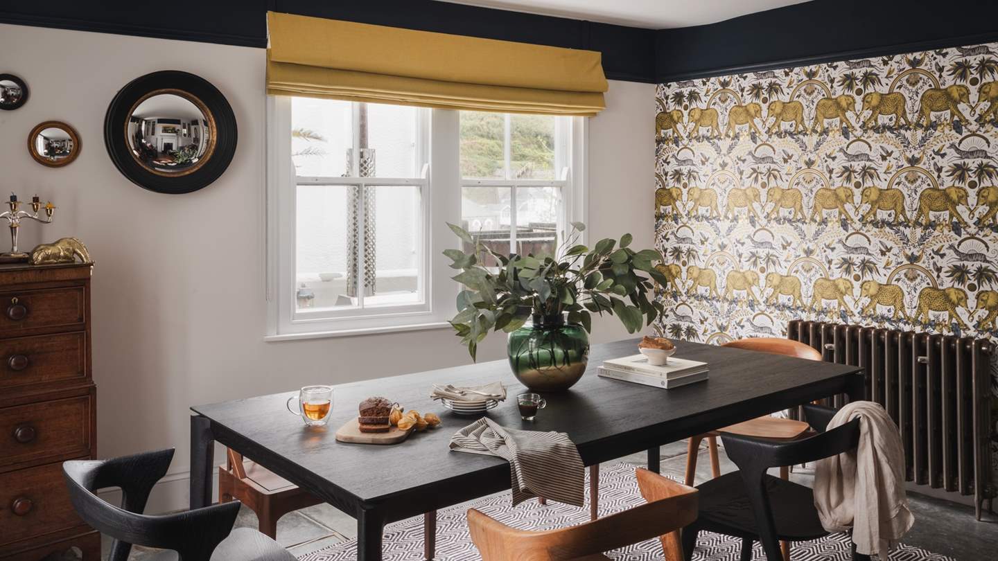 Striking gold and black tones adorn this beautiful space, adorned with dreamy décor including Emma J Shipley and Clarke & Clarke Zambezi wallpaper