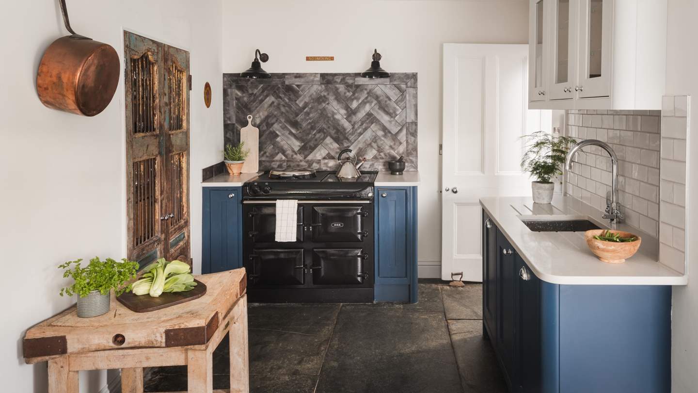 Seamlessly blending a vintage farmhouse aesthetic with modern comforts, Maren’s gorgeous kitchen is adorned in white walls and awash with natural light