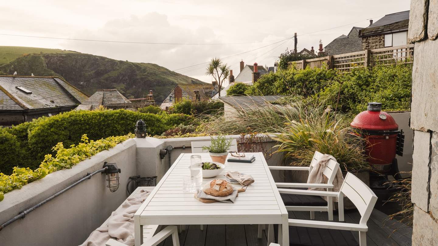 Encouraging alfresco moments, an enclosed decking area is home to a Heals aluminium dining table which comfortably seats four and a bench for meals together