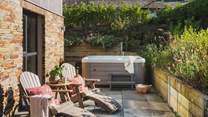 Positioned before a bed of beautiful wildflowers, you'll find the bubbling hot tub