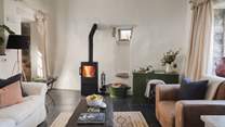 Settle into the living area, where a wood burning stove exudes warmth in the cooler months

