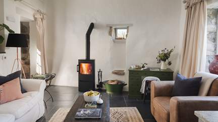 Settle into the living area, where a wood burning stove exudes warmth in the cooler months

