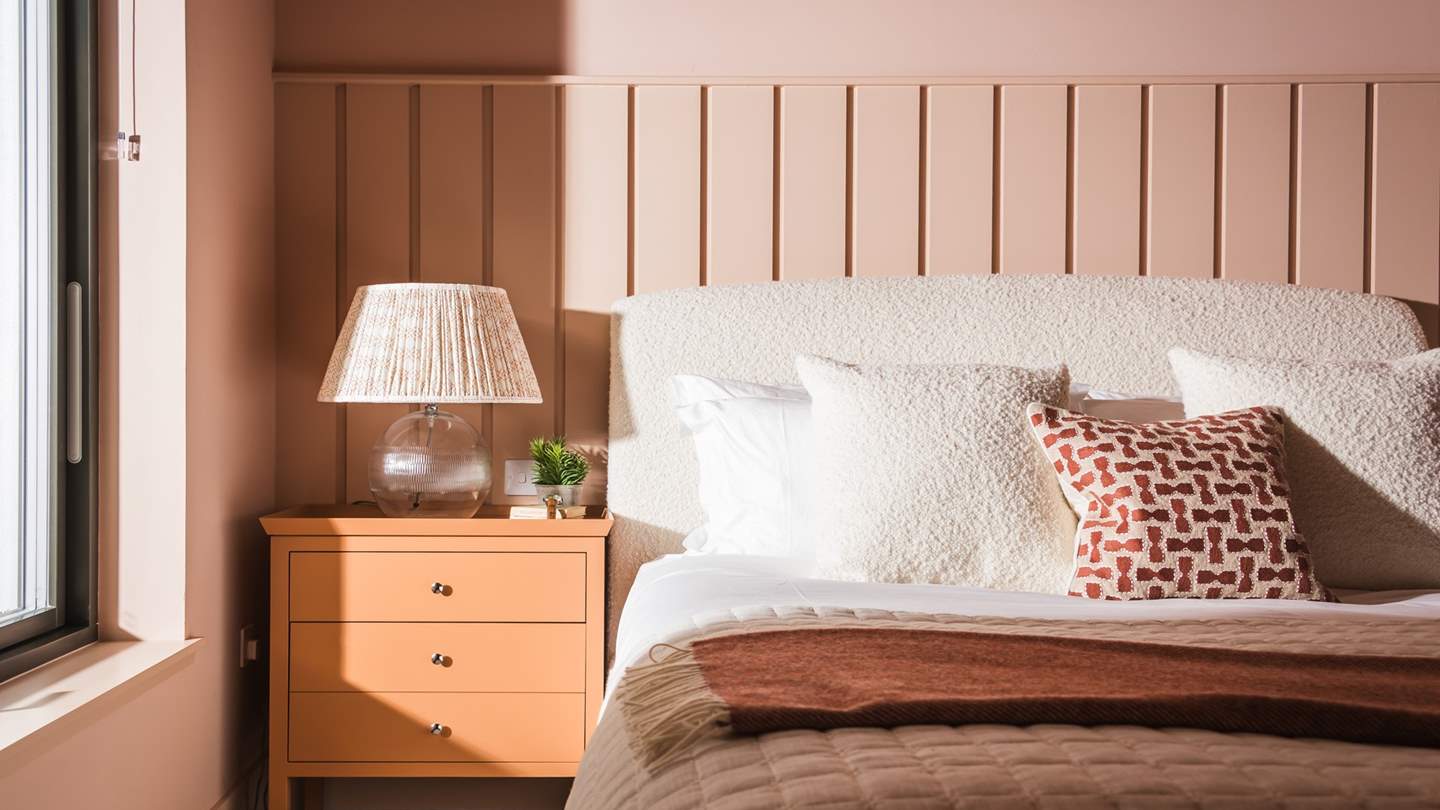 There’s hanging space for storing belongings, with the addition of bedside tables topped with beautifully crafted table lamps to create a serene setting to unwind