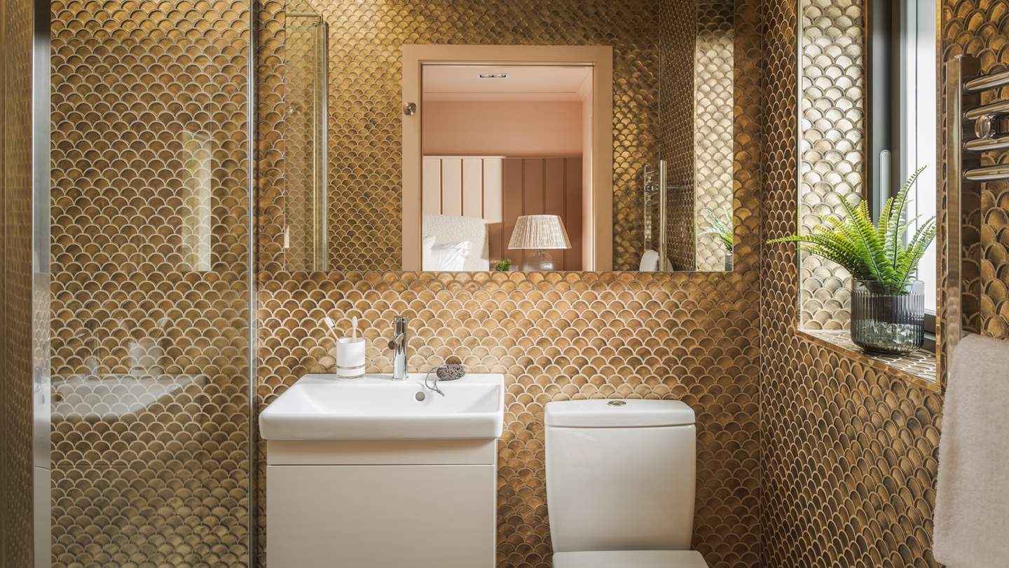 For those luxurious self-care rituals, step into the ensuite shower room with an inviting rainfall shower 