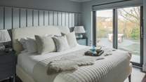 Swathed in soothing shades of powder blue, the second bedroom boasts ethereal views across the expansive Loch Dunvegan 