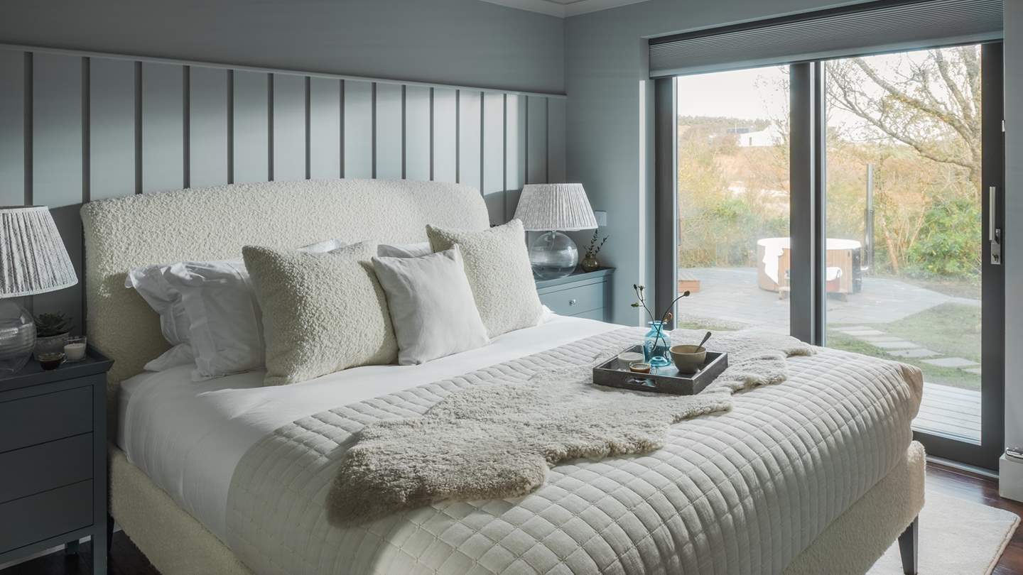 Swathed in soothing shades of powder blue, the second bedroom boasts ethereal views across the expansive Loch Dunvegan 