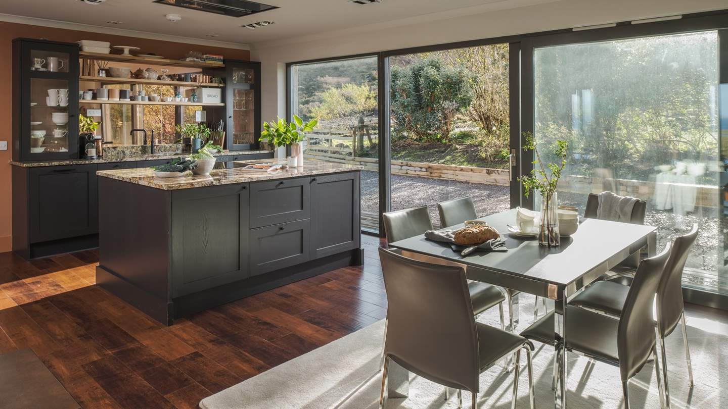 Blending contemporary design with opulent touches, the kitchen and dining space beckons for heavenly suppers