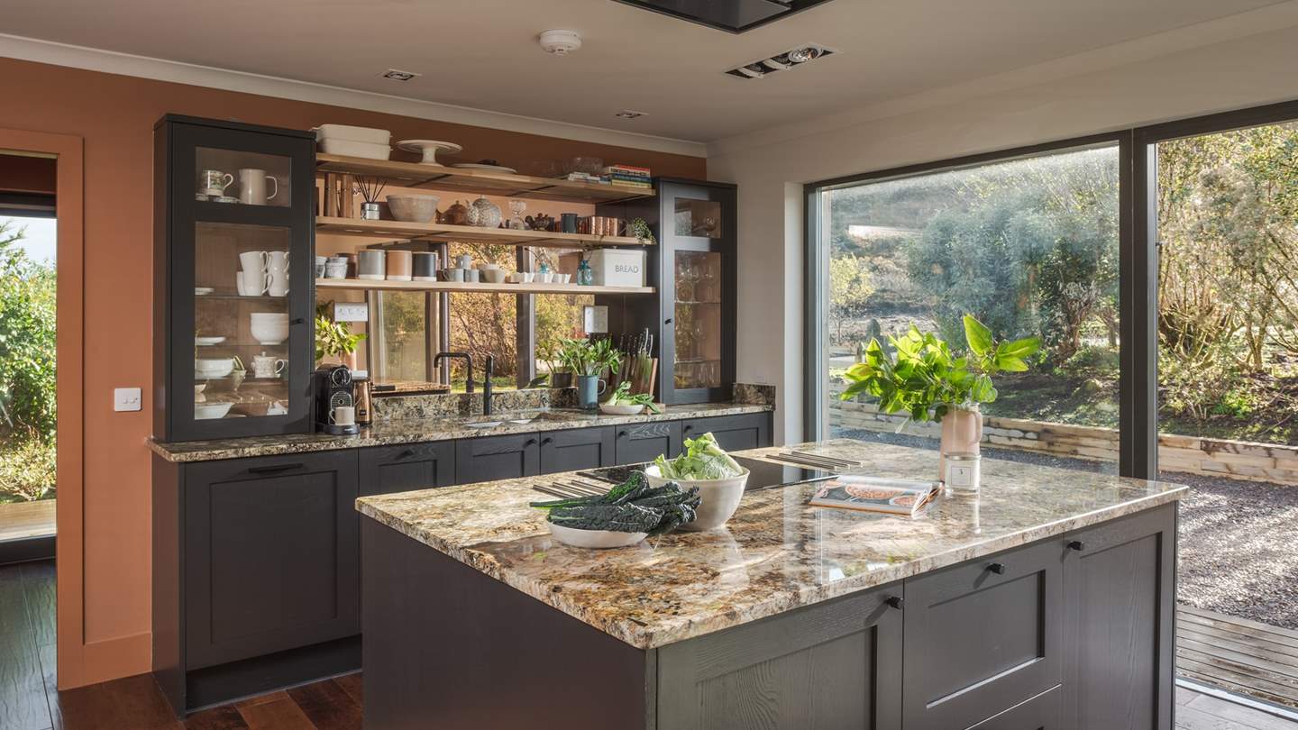 The granite-topped kitchen is fully equipped with a range of integrated appliances