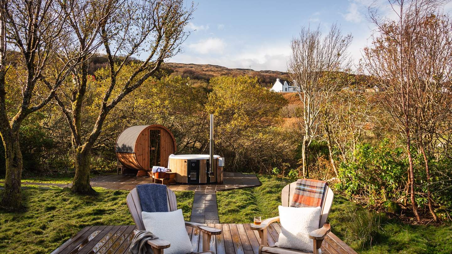 A set of steps lead to a modern gas firepit, with relaxed seating for four