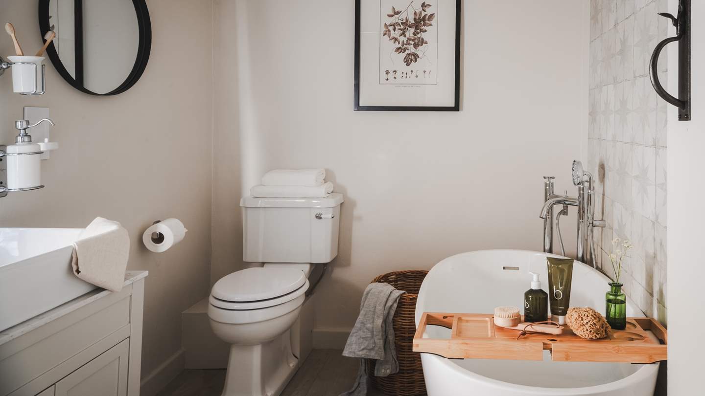 The bathroom is positioned on the first floor, complete with a freestanding bath and walk-in shower 