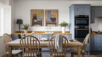In the centre of the kitchen and dining space, a family-sized dining table with chairs for six beckons for breakfasts and banquets 