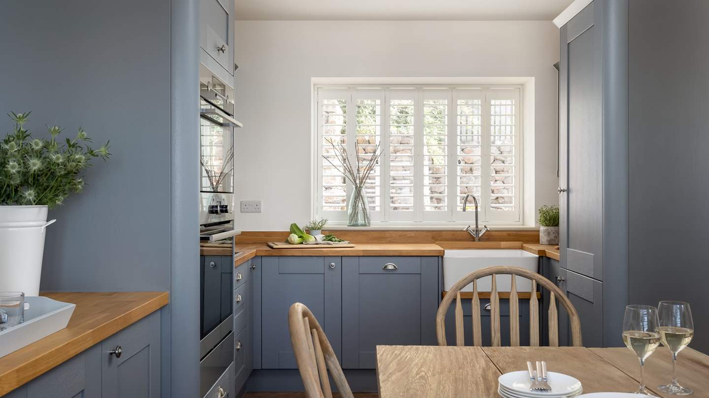 Tiered slate-blue cabinetry hosts an array of equipment for culinary artists