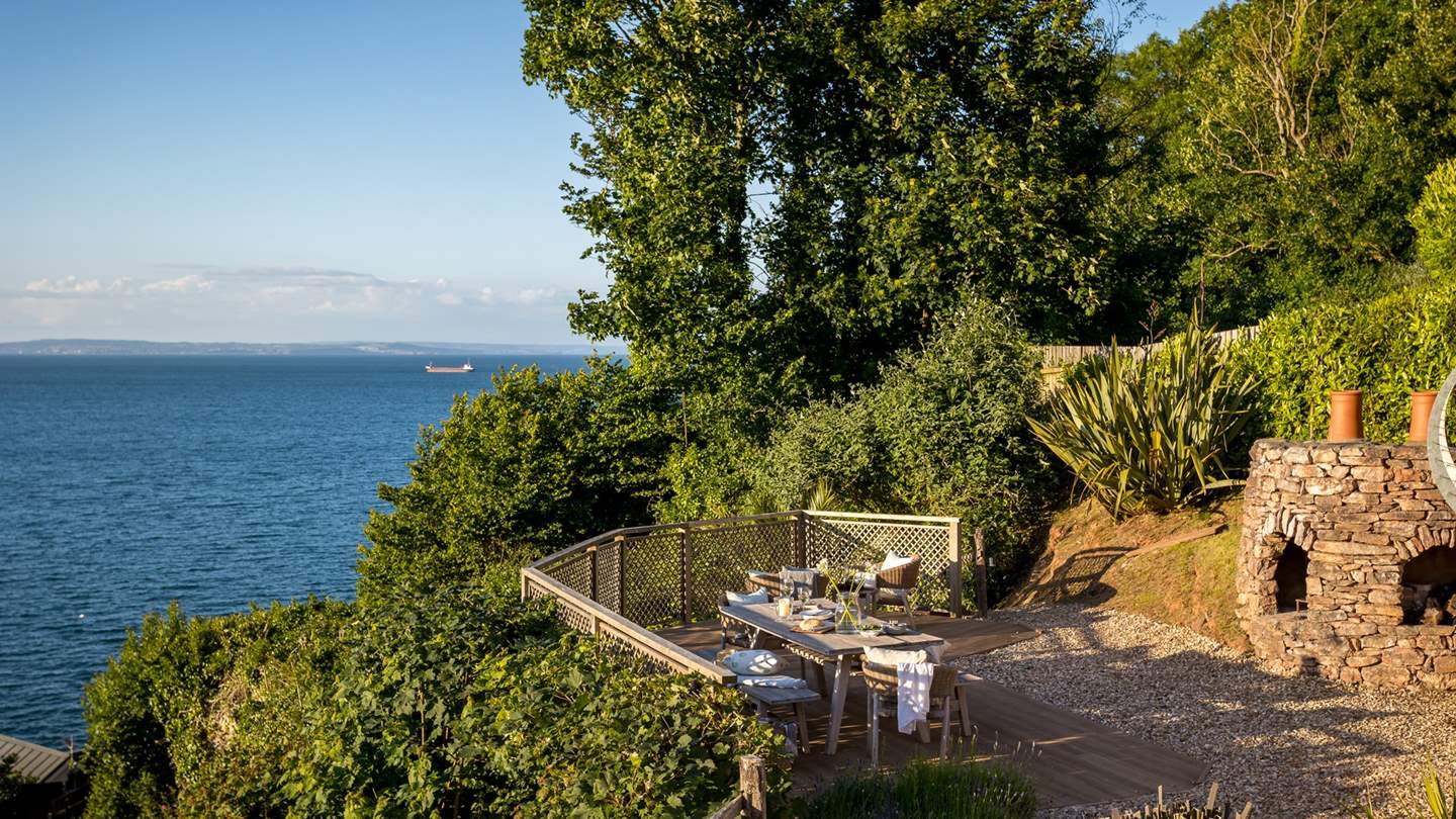 Framed by greenery and overlooking open sea, this heavenly space tempts for blissful moments under open skies